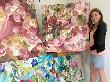 Artist Amber Gittins holding Abstract floral original paintings
