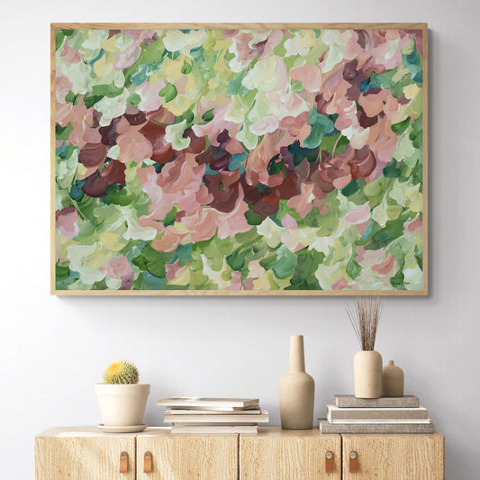 Modern nature art print in contemporary colours of warm brown and pinks and natures green. Contemporary impressionist simple style. Framed in a natural frame and hanging against a living room wall.