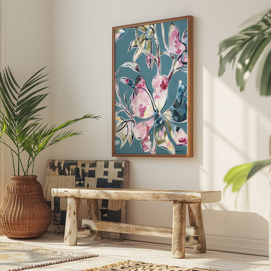 Modern blue and pink abstract flower art print with a natural frame hanging in a modern living room.