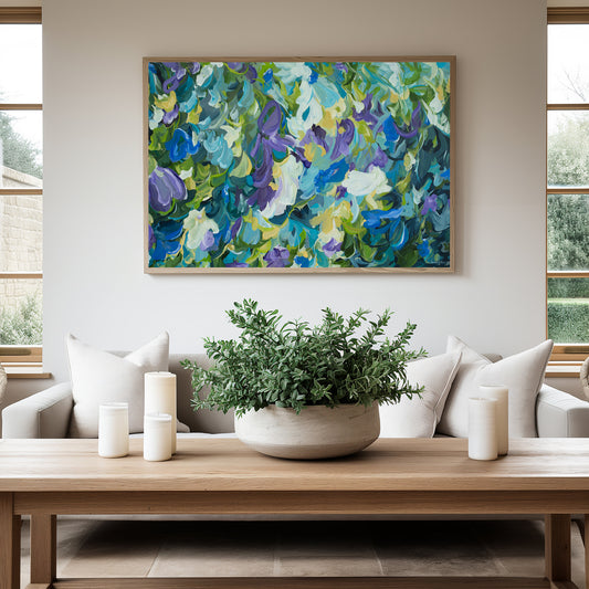 Contemporary abstract floral fine art print in blue, purple, green and yellow. Hanging against a modern neutral living room wall with a natural frame.
