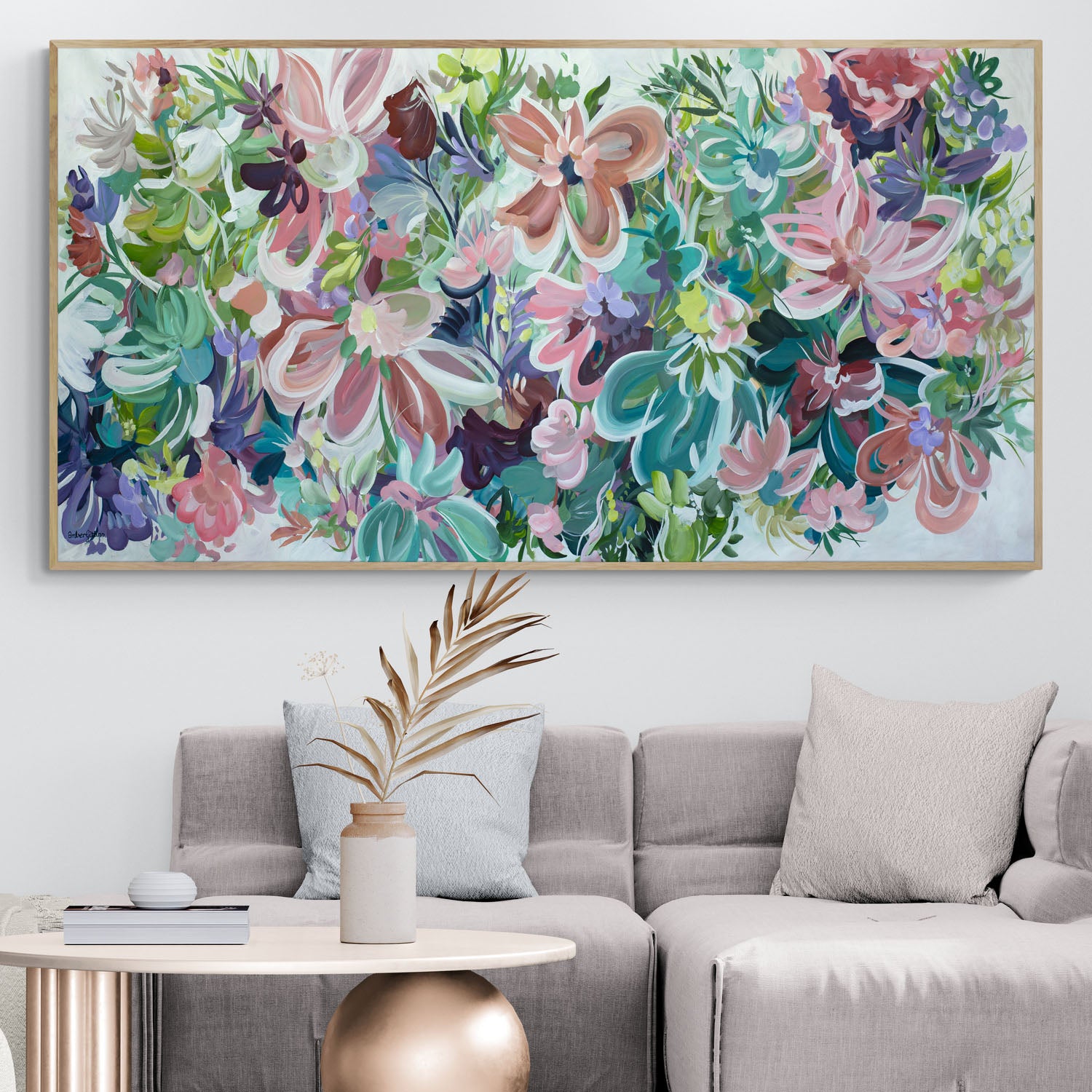 Large colourful abstract flower painting with a natural frame, hanging in a neutral beige lounge room