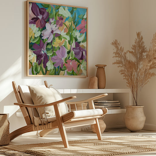 Colourful flower fine art print in a modern layered style with purple, green, pink, blue and warm yellow colours. Framed in a natural frame hanging in a modern neutral lounge room.