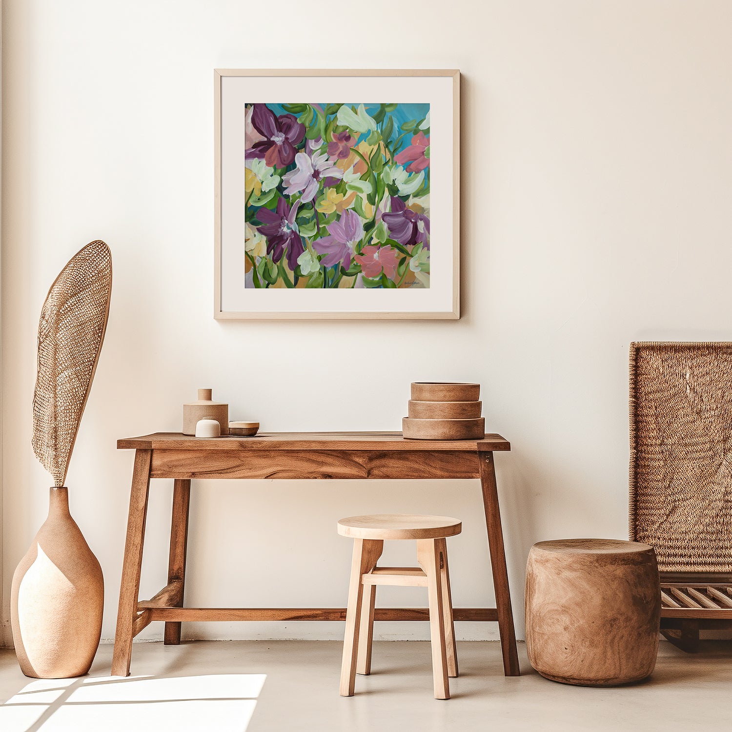 Colourful flower fine art print in a modern layered style with purple, green, pink, blue and warm yellow colours. Framed in a white frame hanging in a modern neutral lounge room.