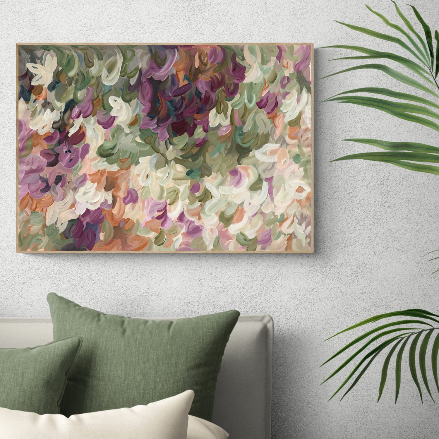 Contemporary abstract art print of nature and leaves in warm tones of burgundy, orange, beige and olive green. Simple impressionist modern design of organic round layered shapes. Framed in a natural frame hanging in a modern bedroom.