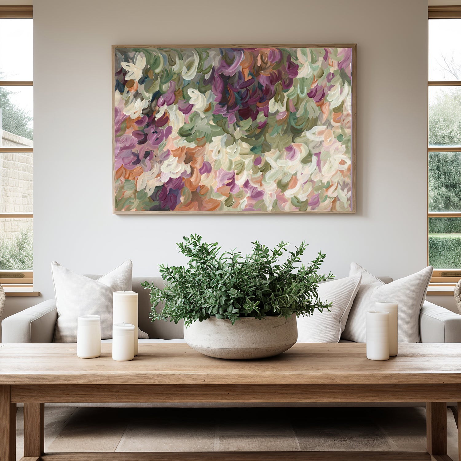 Contemporary abstract art print of nature and leaves in warm tones of burgundy, orange, beige and olive green. Simple impressionist modern design of organic round layered shapes. Framed in a natural frame hanging in a modern living room.