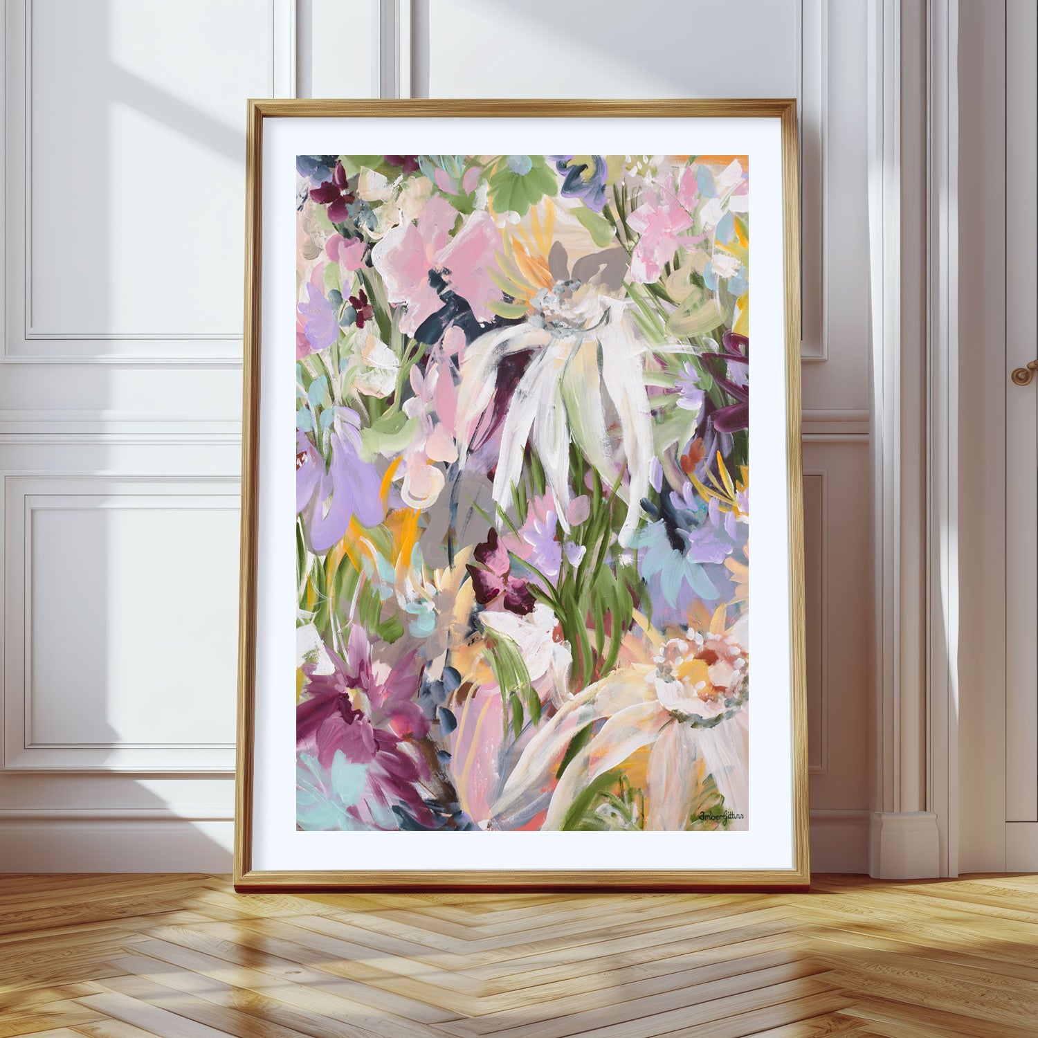 Colourful modern abstract flower art print with a natural frame leaning against a wall