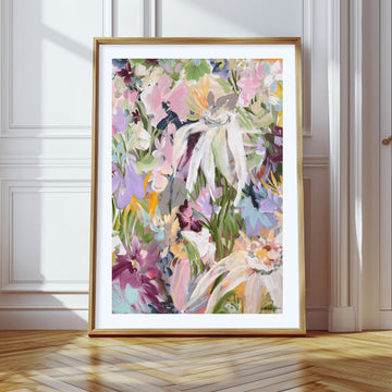 Colourful modern abstract flower art print with a natural frame leaning against a wall