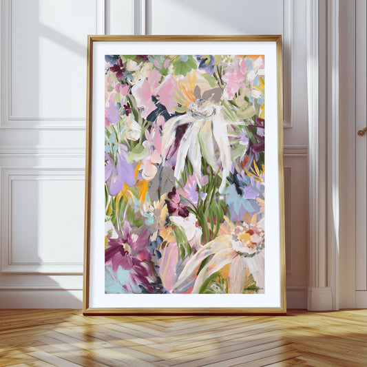 Colourful modern abstract flower art print with a natural frame leaning against a wall