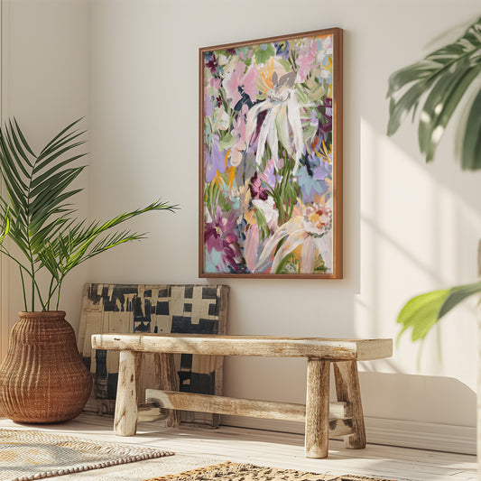 Colourful modern abstract flower canvas art print with a natural frame hanging against a wall