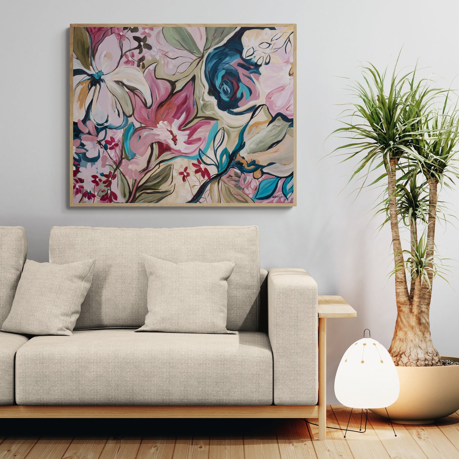 Living room with a floral abstract canvas art print, beige sofa, and potted plant.
