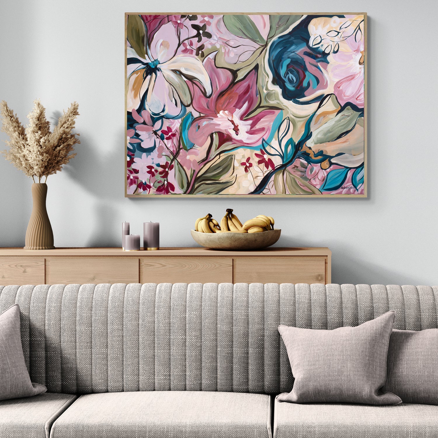 Living room with a floral abstract canvas print above a wooden console table, featuring a bowl of bananas.