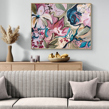 Living room with a floral abstract canvas print above a wooden console table, featuring a bowl of bananas.