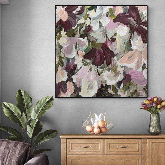 Modern abstract flower painting in pinks and burgundy on a living room wall