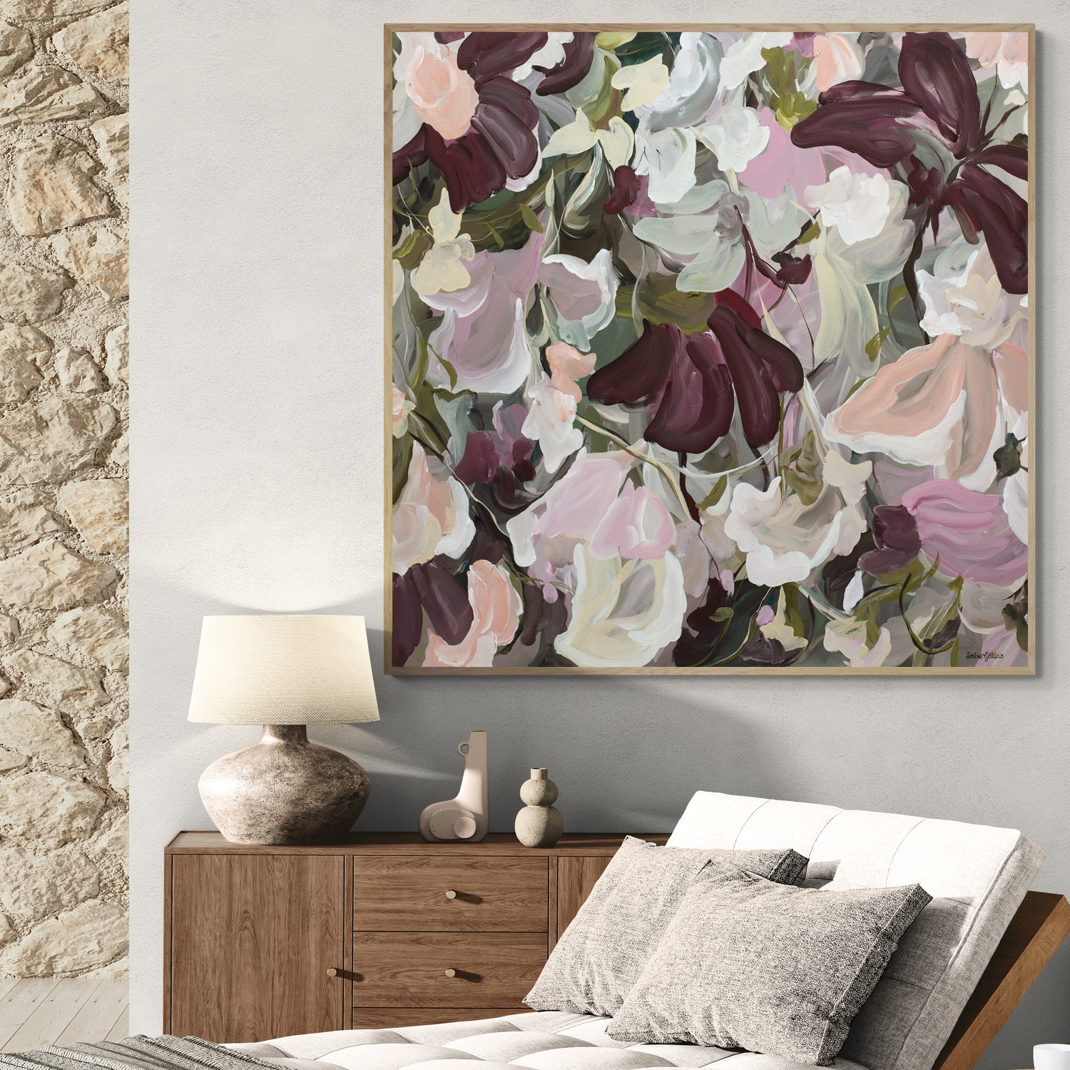 Modern abstract flower painting in pinks and burgundy on a living room wall