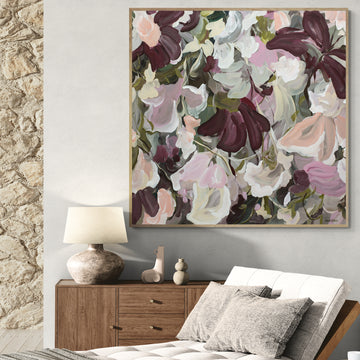 Modern abstract flower painting in pinks and burgundy on a living room wall
