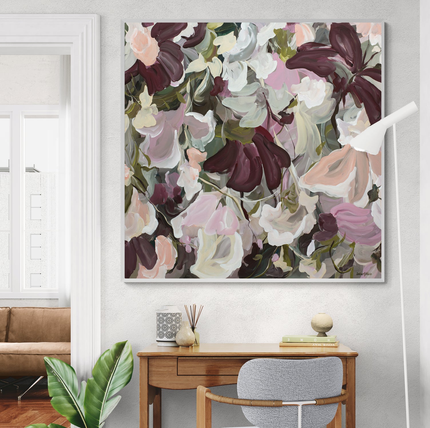 Modern abstract flower painting in pinks and burgundy on a living room wall