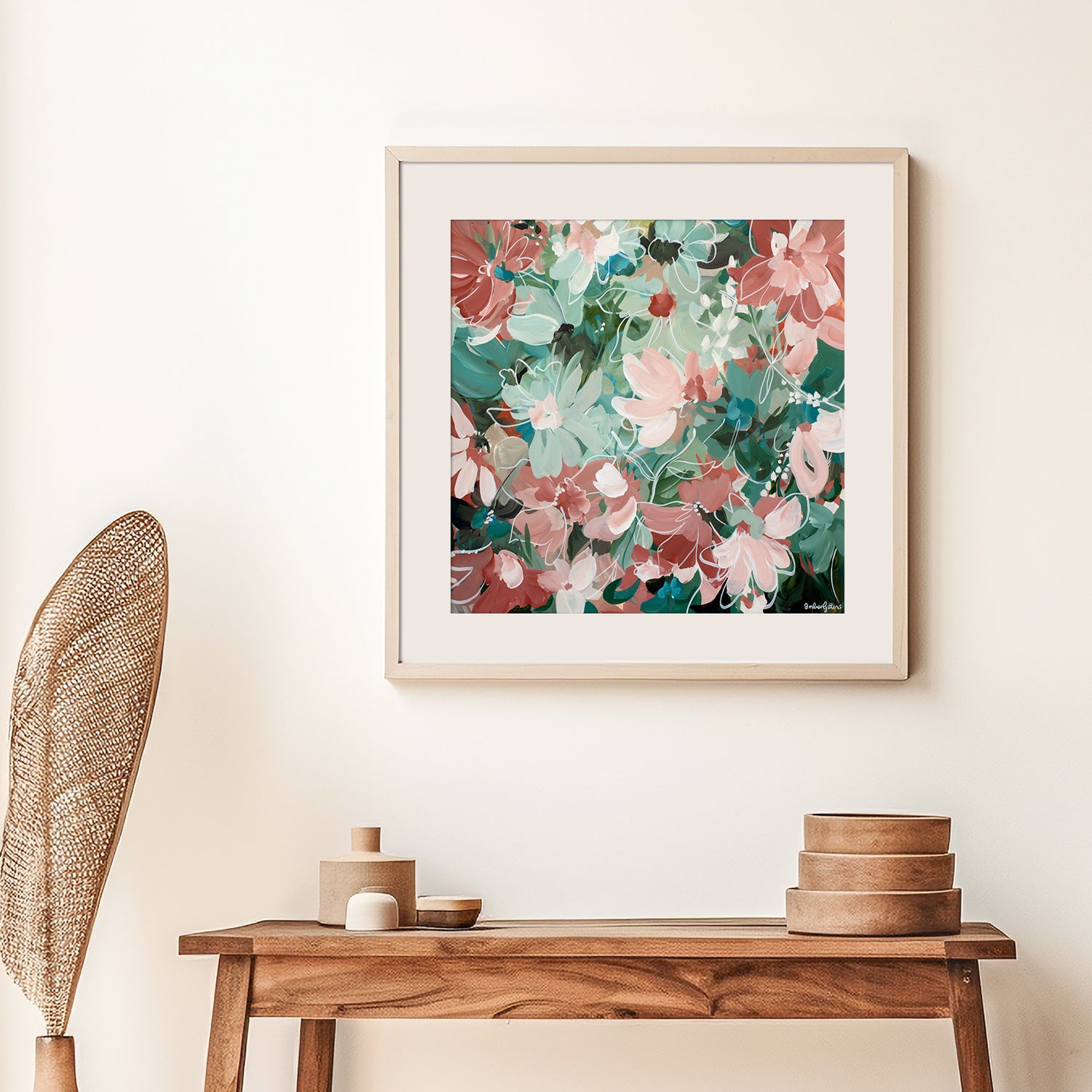 Framed floral abstract fine art print on a wall above a wooden console table with decorative items.