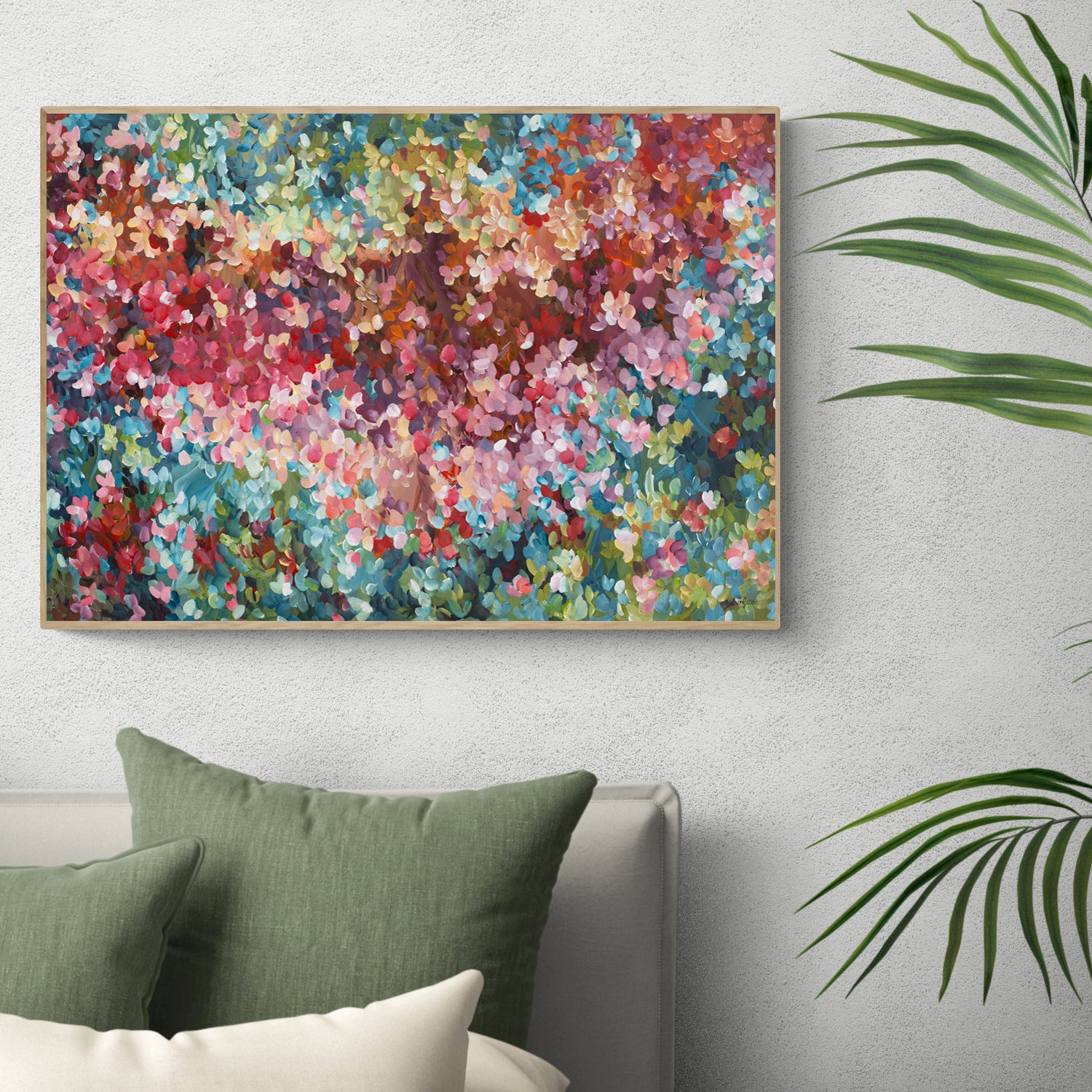 Colourful abstract fine art print. Dots and impressionist style representing small floral petals in nature. Framed in a natural frame, hanging against a modern bedroom wall.