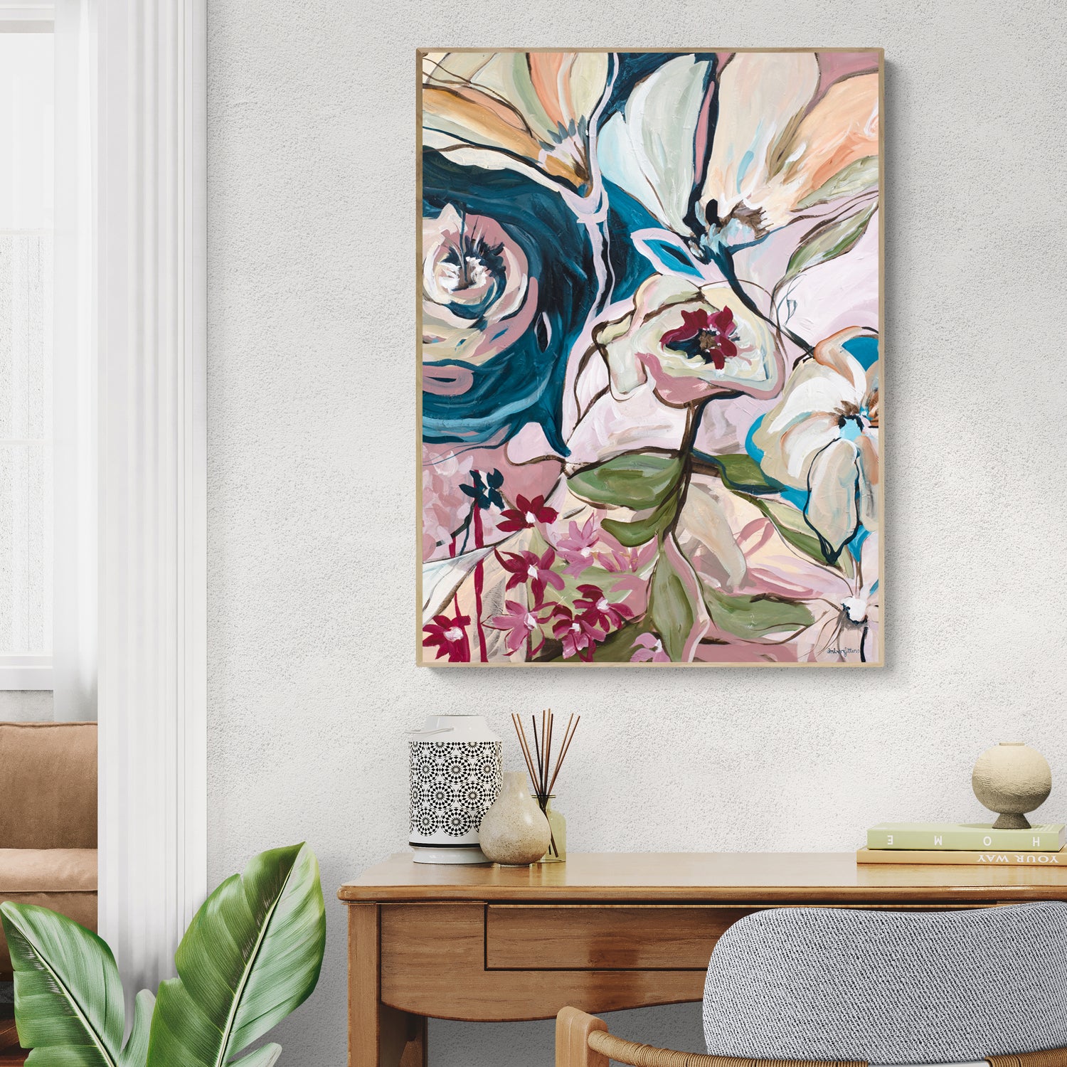 Colourful and fun abstract flower wall art print in an eclectic, bohemian style. Modern canvas wall art  hanging on a living room wall with a natural frame.
