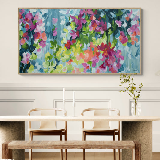 Colorful abstract painting above a dining table with chairs