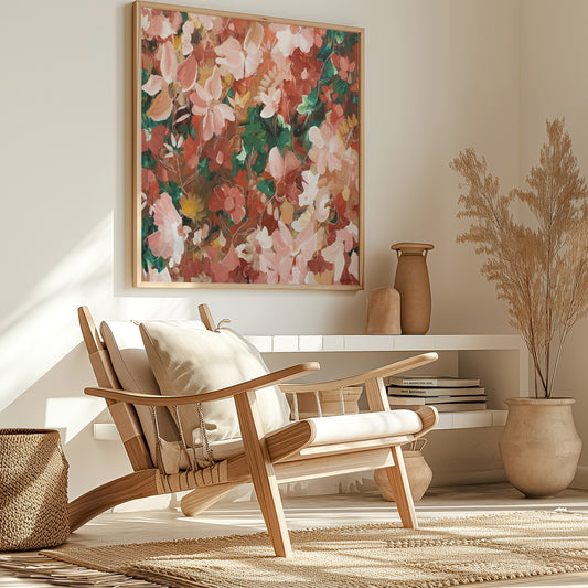 Modern pink and red abstract floral canvas art print hanging in a living room.
