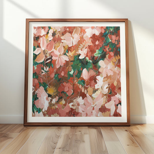 Framed pink and red abstract floral artwork on a wall with wooden floor