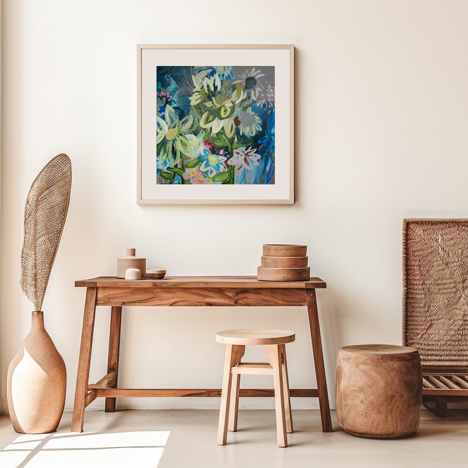 Contemporary square abstract flower fine art print in multi colours. Inspired by sunflowers in the moonlight. Layers of organic flowing shapes and colours in a playful style. Framed in a white wood frame hanging in a modern living room.