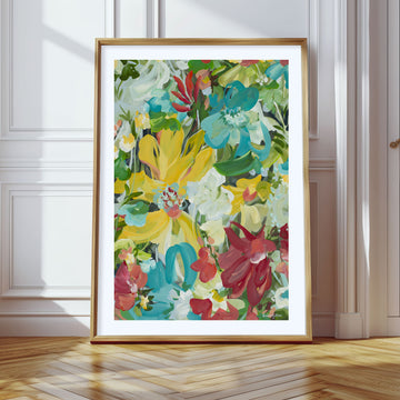 Colourful abstract flower art print leaning against a living room wall.