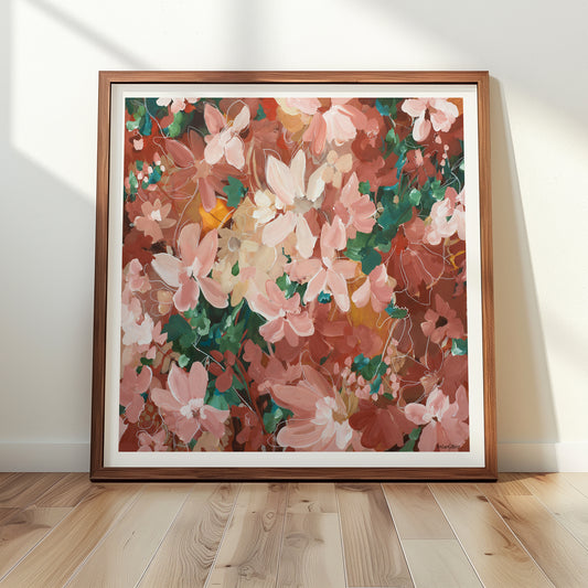 Framed modern floral artwork in pinks, browns and reds on a wall with wooden floor