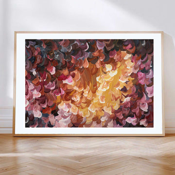 Fiery red and orange abstract flower art print with a natural frame.