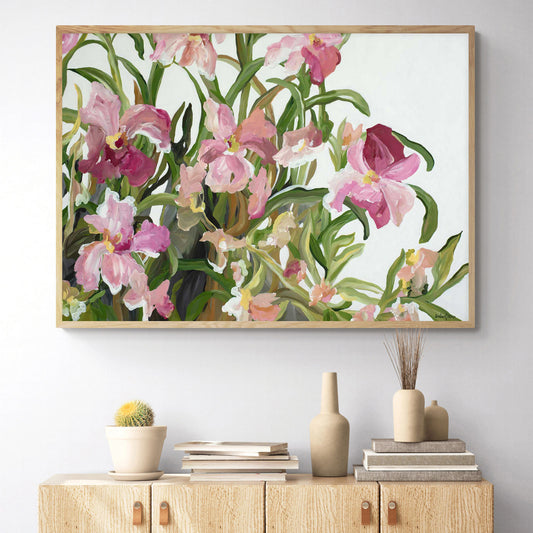 Pretty pink flowers and green leaves with a white background. Wall art canvas print hanging on a wall.