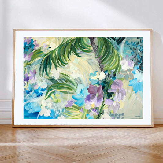 Abstract tropical  fine art print of palm trees and an oasis with purple and light blue tropical flowers. With a natural frame leaning against a wall.