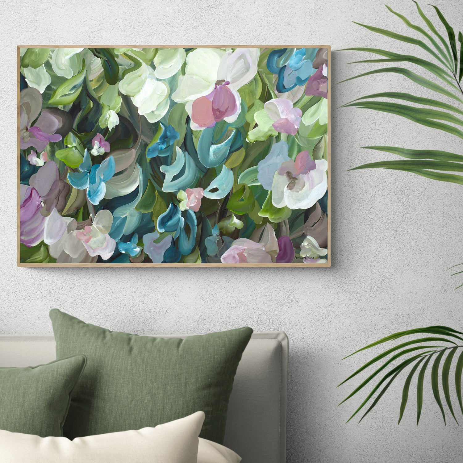 Pretty modern impressionist style abstract floral wall art print in greens, turquoise and pink colours. Framed in a natural frame hanging on a bedroom wall.