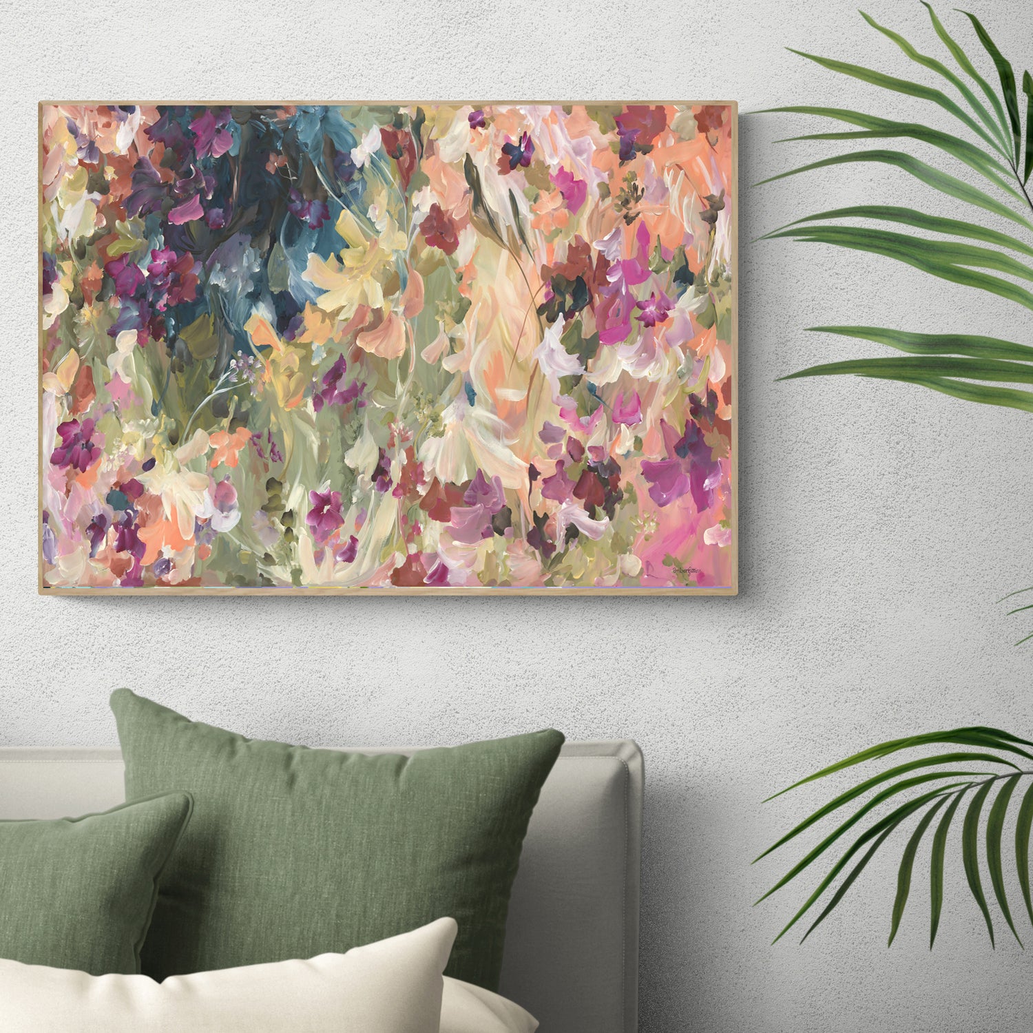 Modern colourful abstract wildflower art print in warm colour palette of pinks, red, orange, yellow and moss greens. Pretty feminine style of wildflower petals in a garden. Framed in a natural frame and hanging against a modern bedroom wall.