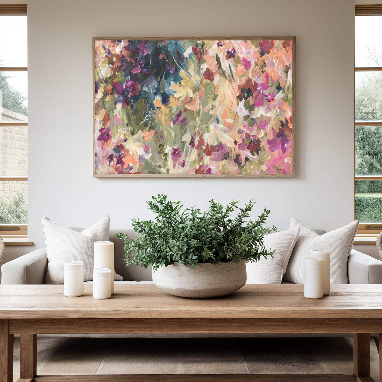 Modern colourful abstract wildflower art print in warm colour palette of pinks, red, orange, yellow and moss greens. Pretty feminine style of wildflower petals in a garden. Framed in a natural frame and hanging against a modern neutral lounge room wall.