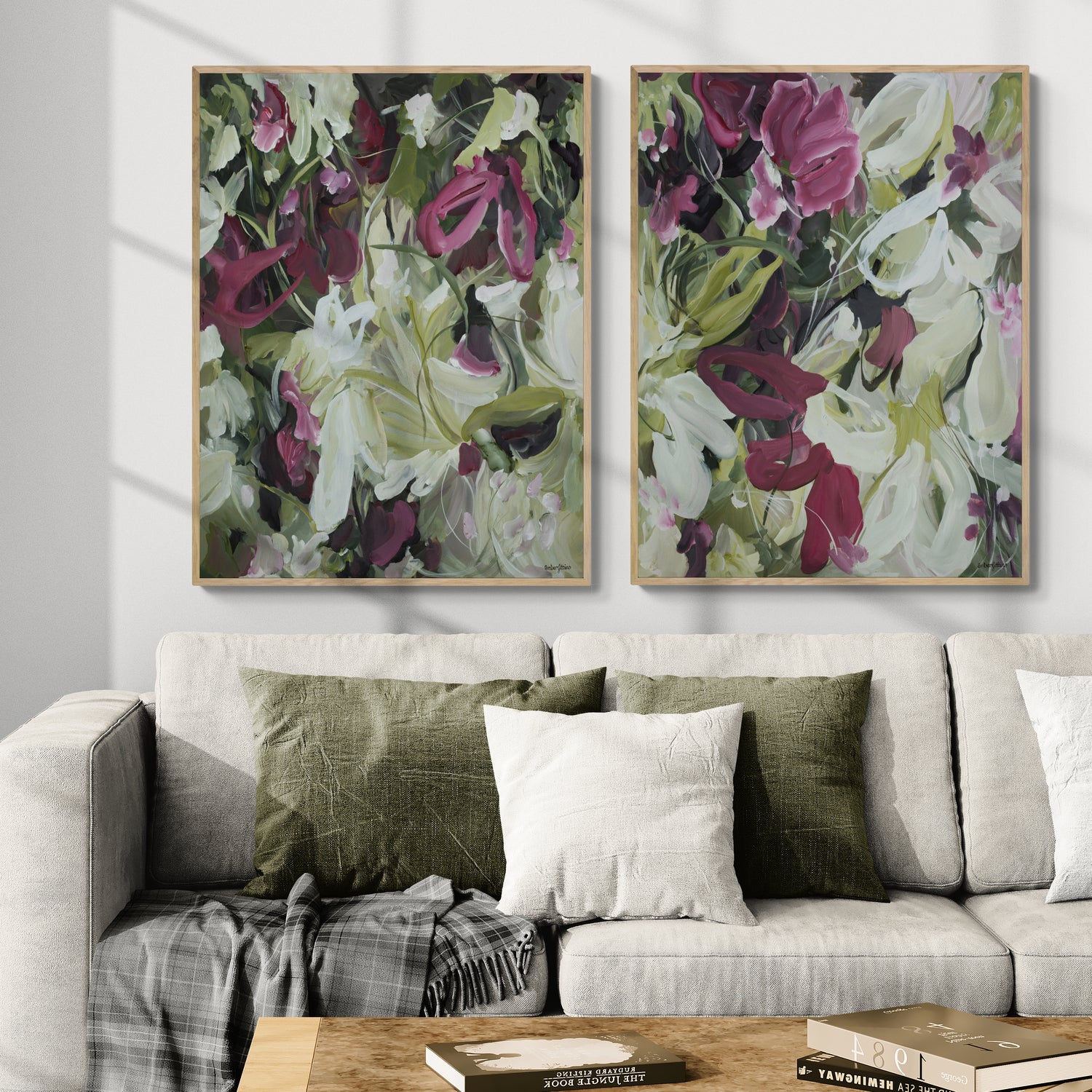 Two modern wildflower fine art prints in an expressive style in modern colour palette of burgundy, white and green. Abstract floral flowing shapes layered over each other. Framed in a natural frame and hanging side by side against a modern neutral earthy living room wall.