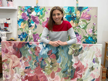 Artist Amber Gittins in her art studio with flower abstract original paintings