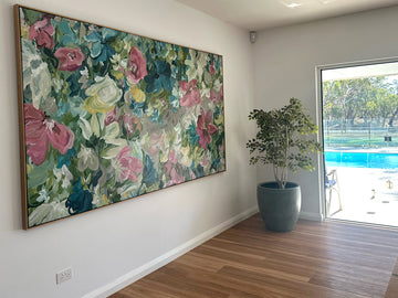 Large colourful abstract flower original painting hanging in a modern living room