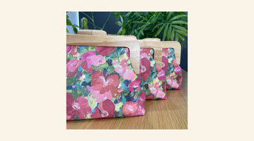 clutches and purses in a pink flower design fabric