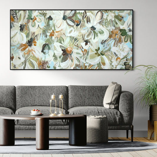 Living room with a gray sofa, coffee table, and floral painting on the wall.