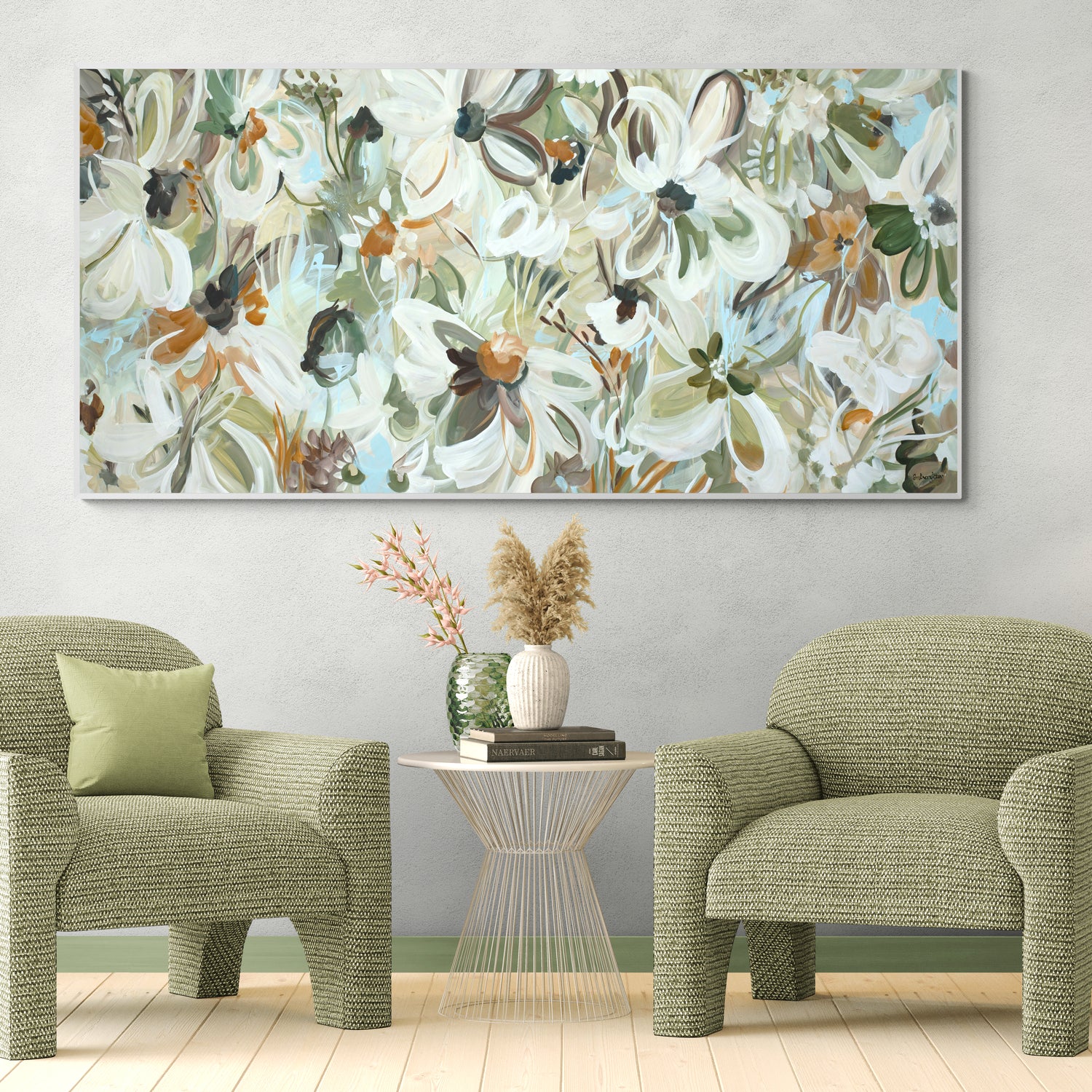 Floral painting above two green chairs in a room with a small table and decorative items.