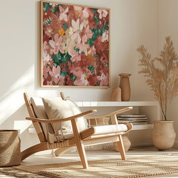 Wooden armchair with an abstract floral canvas art print above it in a room with decorative elements.