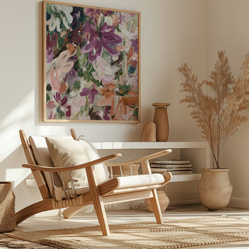 Colourful modern abstract flower fine art wall print in warm tones of red, burgundy, pink, orange and green. Layers of flowing brushstrokes showing linear flower and petal shapes. Framed in a natural frame, hanging against a living room wall.