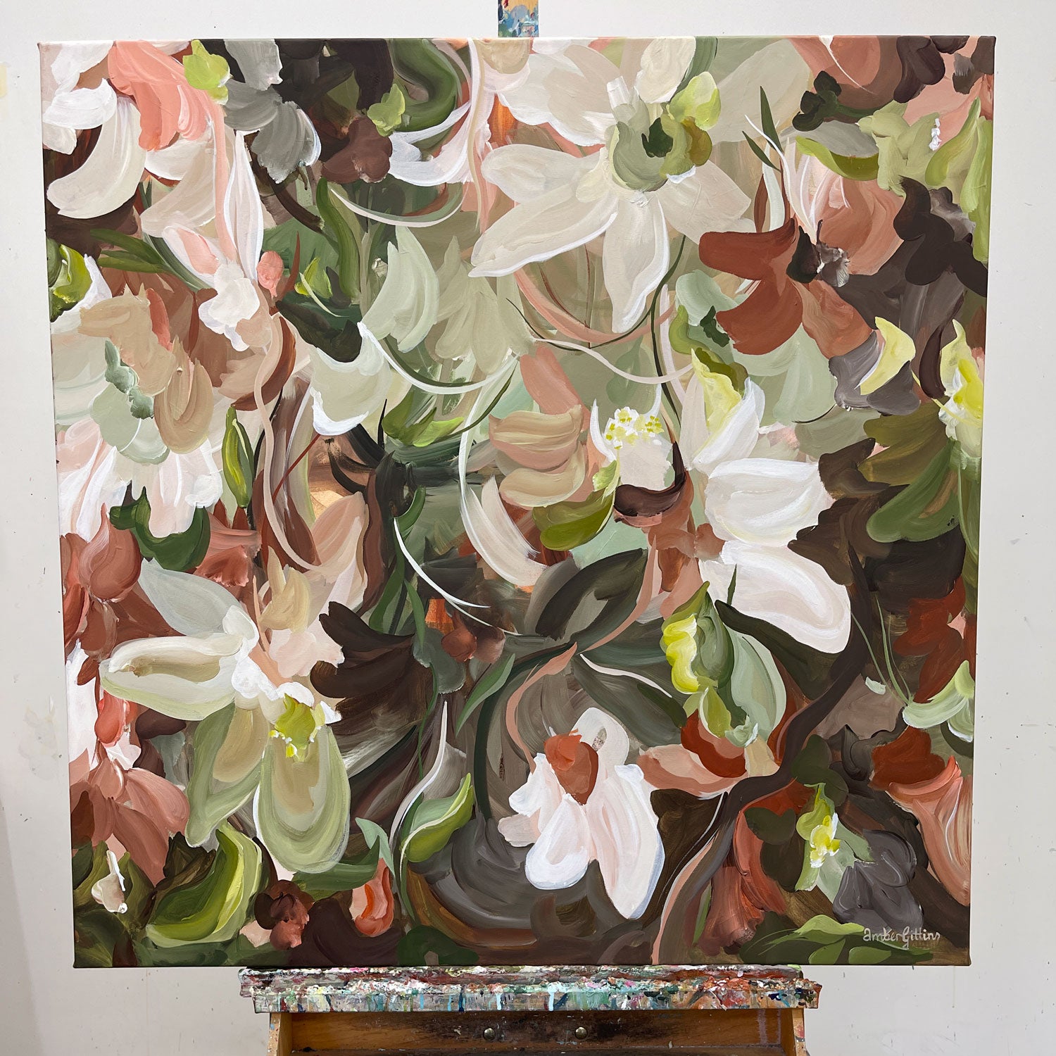 Brown and green botanical painting on an easel with a white background