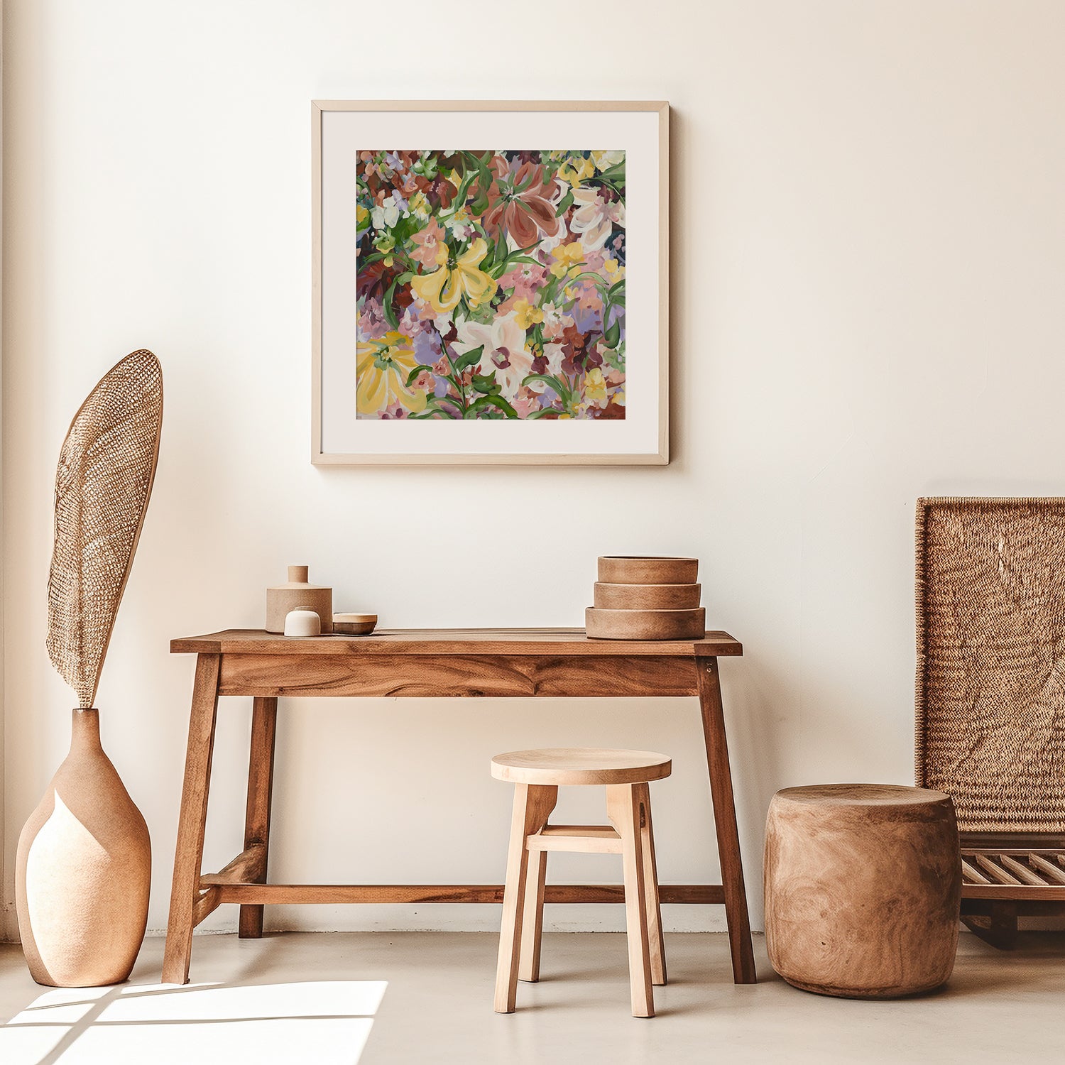 Natural and earthy wildflower abstract wall art print in neutral tones of brown, apricot, green, lilac and yellow. Layers of flower petals in a modern style. Framed in a white frame, hanging on a modern neutral living room wall.