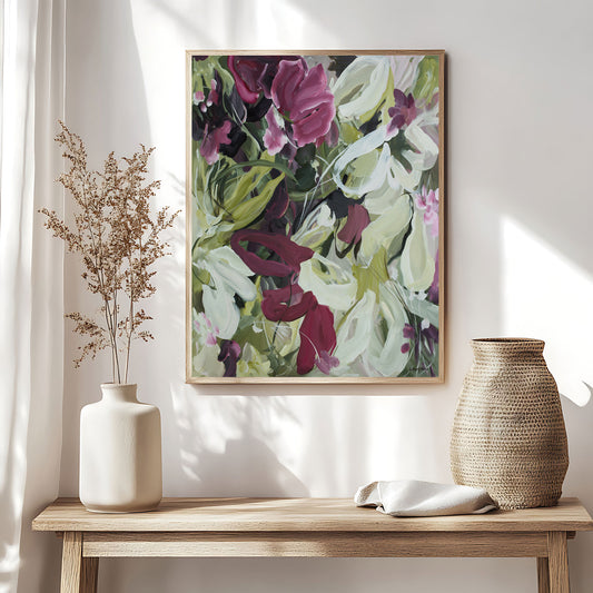 Modern wildflower fine art print in an expressive style in modern colour palette of burgundy, white and green. Abstract floral flowing shapes layered over each other. Framed in a natural frame and hanging against a modern neutral living room wall.